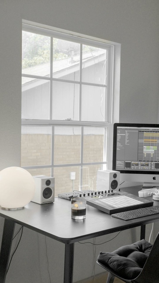 A minimal desk with a monitor in a bright room